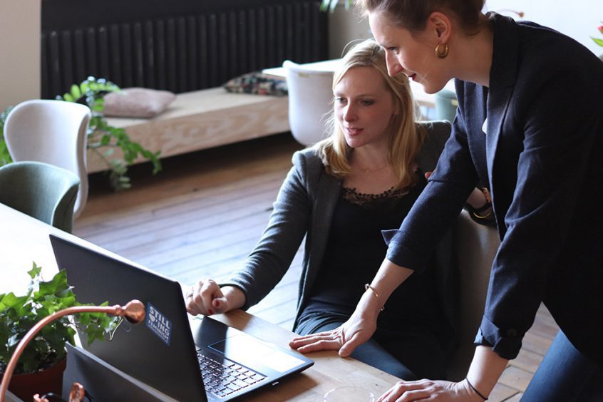 Two women looking at laptop