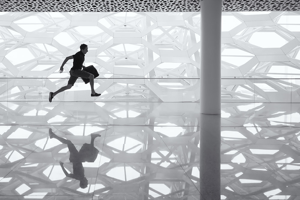 Man running with briefcase through hallway